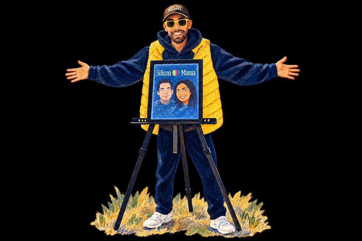 Adil with open arms behind a Silicon Mania magazine on an easel.